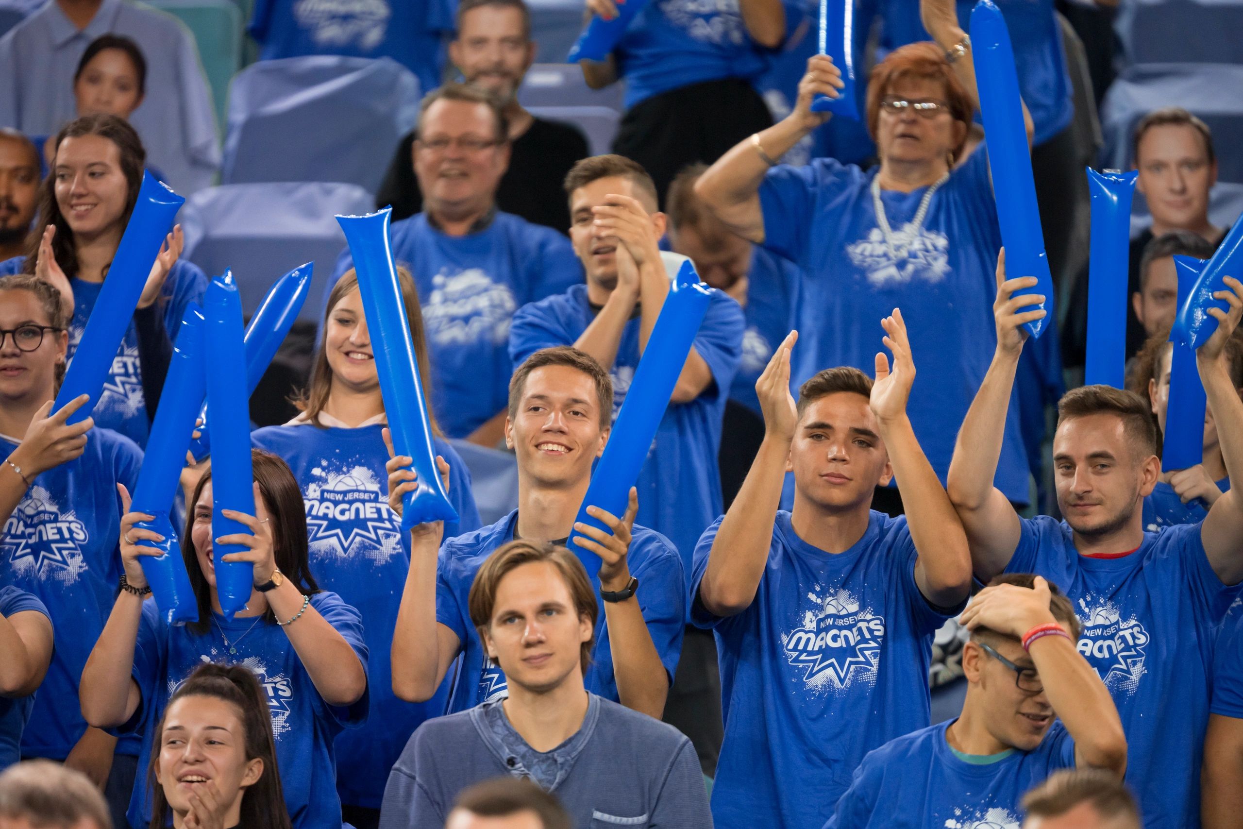 Crowd cheering during a high-energy fan gathering