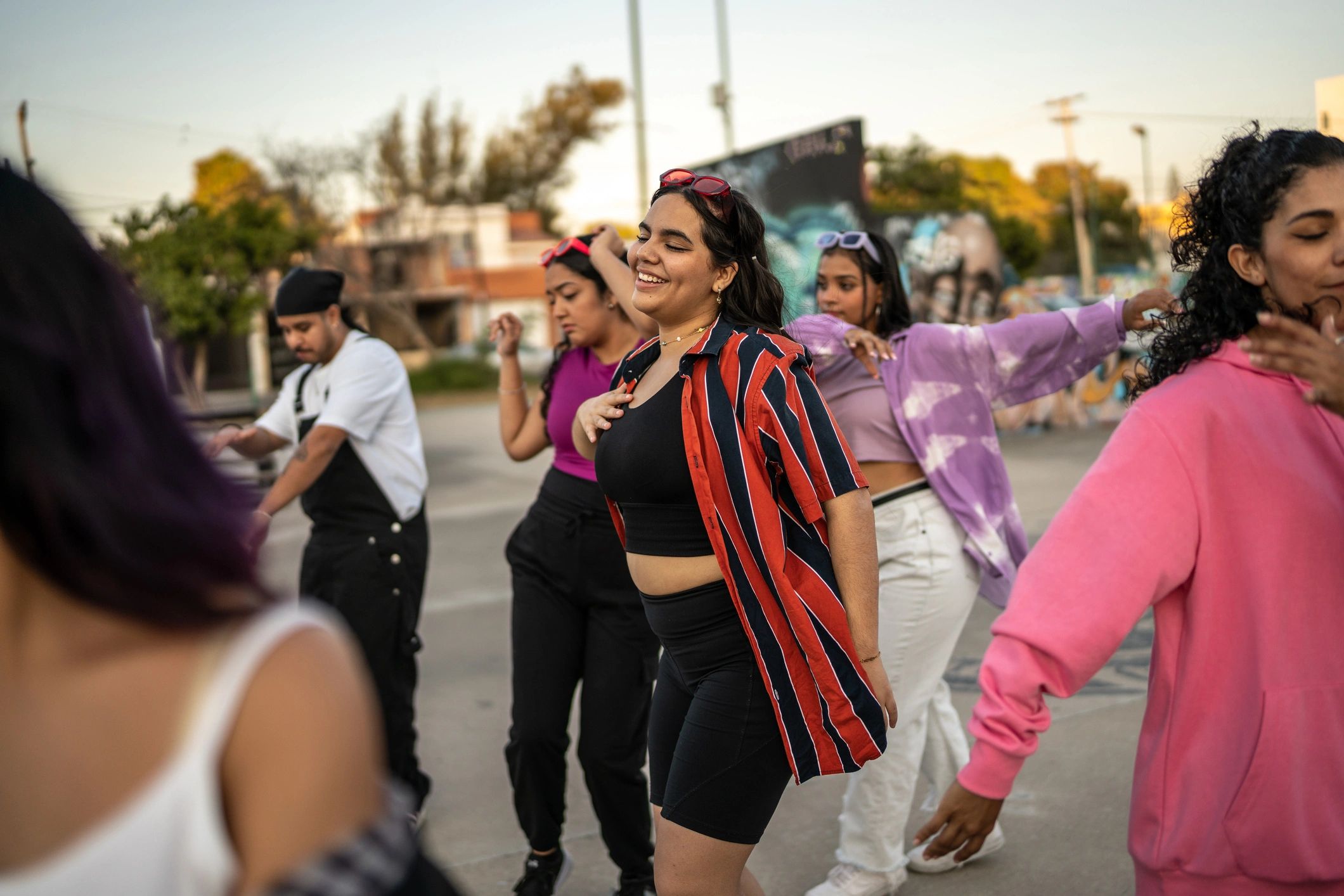 Friends dancing and enjoying an outdoor fan event