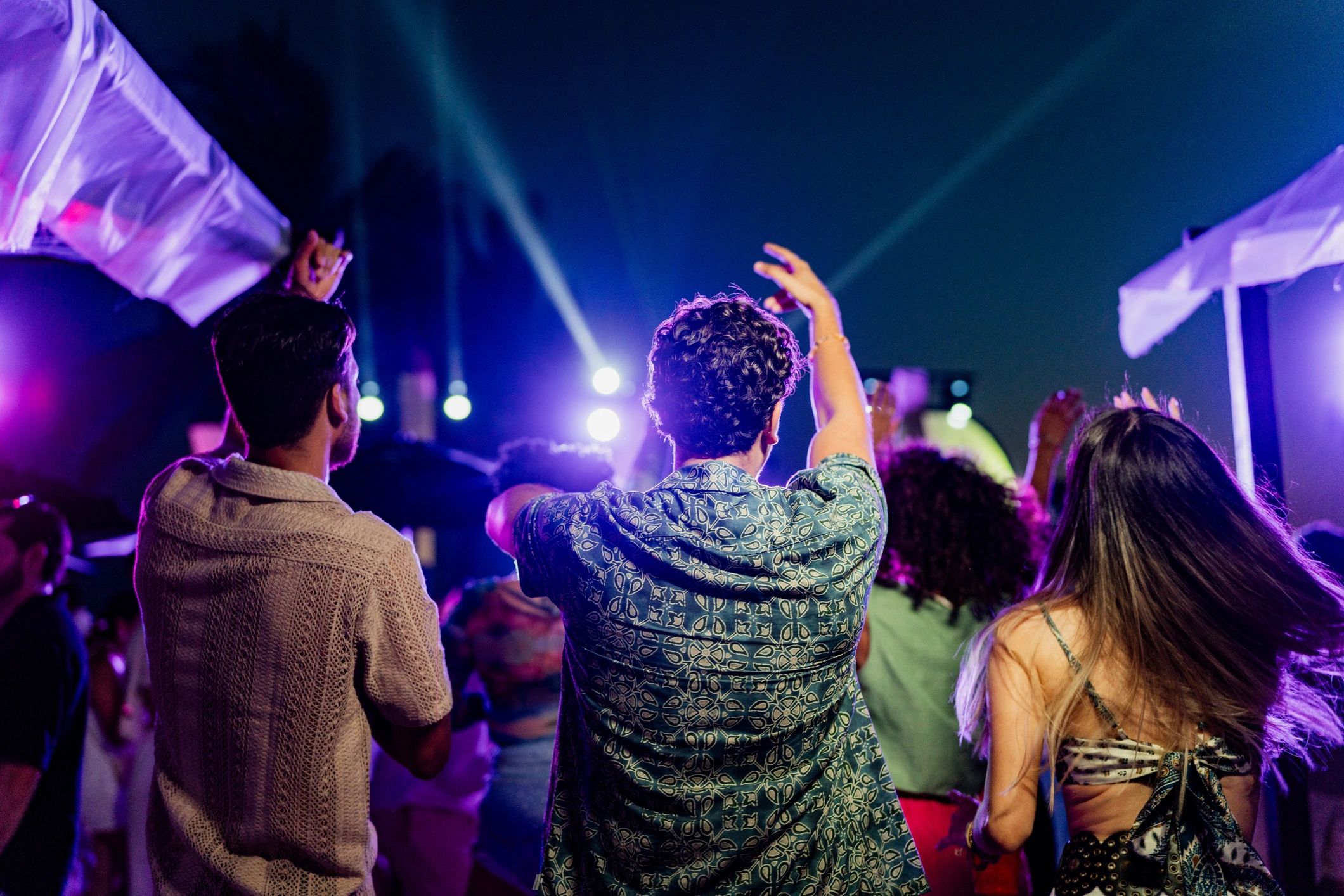 Friends enjoying an energetic outdoor night event